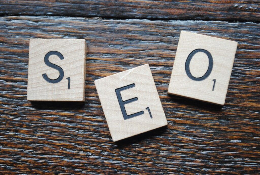pexels-photo-12813050-12813050 Close-up of Scrabble tiles spelling SEO on a wooden table for content strategy.